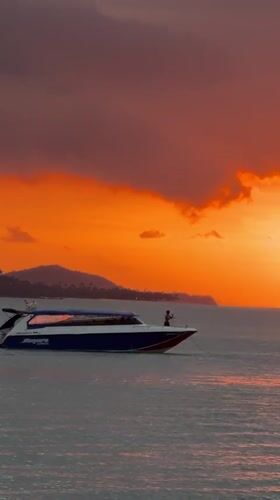 Speedboat Siriwan cruises Baan Bang Rak waters at sunset
