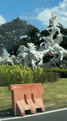 Driver eating with spoon near horse statue in Kuta