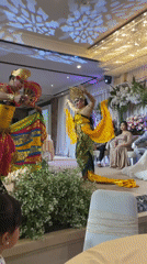 Wedding reception features traditional Balinese dancers in event hall