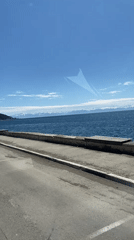 Vehicle travels waterfront road in Listvyanka, Russia