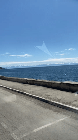 Vehicle travels waterfront road in Listvyanka, Russia