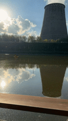 Industrial towers reflected in Moscow park water