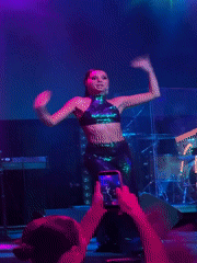 Live stage performance in Georgia, green outfit, DJ and drums
