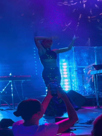 Live stage performance in Georgia, green outfit, DJ and drums