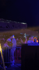 Nighttime crowd event under colored lights in Sozopol