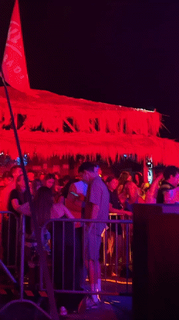 Nighttime crowd event under colored lights in Sozopol