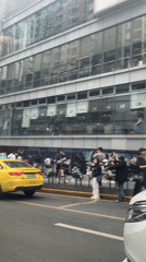 Yellow taxis and pedestrians on busy Chongqing street
