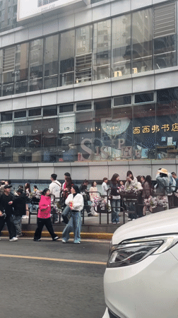 Yellow taxis and pedestrians on busy Chongqing street