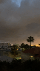 Sunset documented over Raanana cityscape amid overcast skies