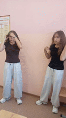 Students exercise and use phones in pink classroom