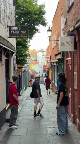 Casual street activity documented in Nottingham's Hurts Yard alleyway