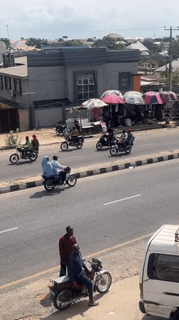 Motorcycle taxis operate on residential street in Lokoja