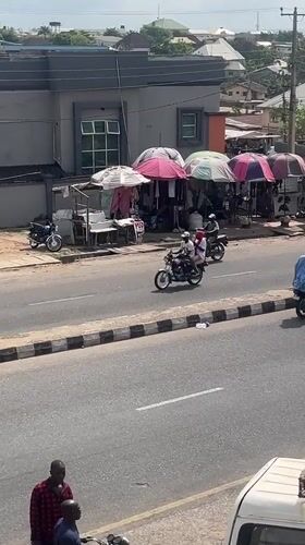 Motorcycle taxis operate on residential street in Lokoja