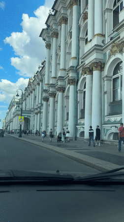 Horse carriages and traffic near Saint Petersburg's Admiralty on a summer morning