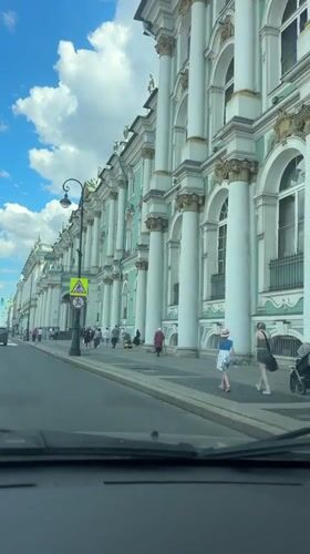 Horse carriages and traffic near Saint Petersburg's Admiralty on a summer morning