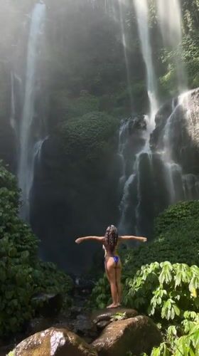 At the base of a jungle waterfall in Sawan, Indonesia