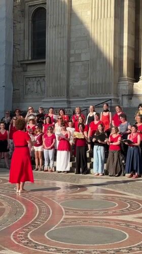 Women's choir performs on building steps in Budapest