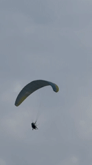 Paragliders soar over Montenegro's cloudy Adriatic coastline