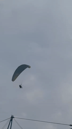 Paragliders soar over Montenegro's cloudy Adriatic coastline