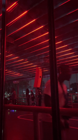 Couples dance under flashing lights in Accra nightclub