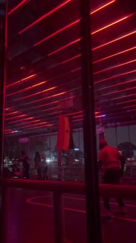 Couples dance under flashing lights in Accra nightclub