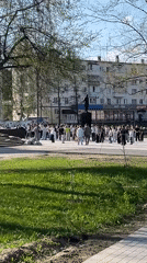 White-clad crowd gathers around statue in Chaikovsky public square