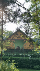 Ornate green building with wooden carvings documented in Moscow