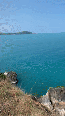 Tourist documents morning clifftop ocean views in Ko Samui