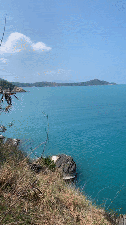 Tourist documents morning clifftop ocean views in Ko Samui