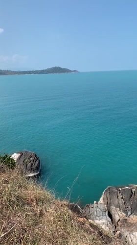 Tourist documents morning clifftop ocean views in Ko Samui
