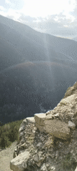 Mountain cliff overlook documented with forest valley views