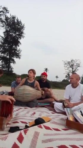 Six people gather on blanket at Arambol beach