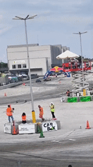 Outdoor car event draws attendees near safety barriers