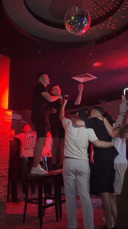 Nightclub scene in Sofia with disco ball and socializing