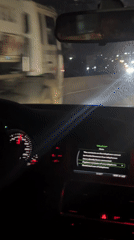 Driver passes wide-load truck on Nigerian highway at night