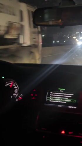 Driver passes wide-load truck on Nigerian highway at night