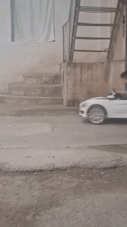 Child enjoys toy car ride in Khujand courtyard