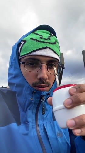 Man drinks from cup outdoors in Ushuaia, Argentina