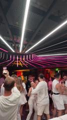 Group dances in white outfits at Đà Nẵng nightclub