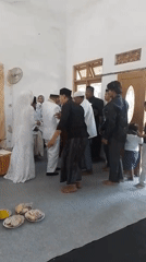 Indoor wedding ceremony with vows, signing, and gathered guests