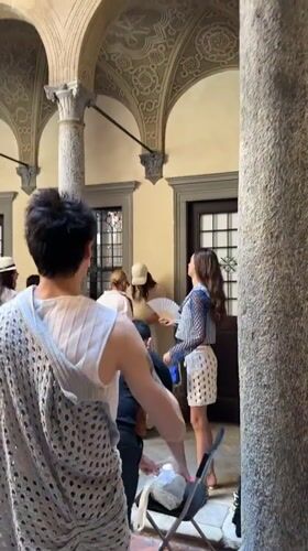 Group gathered in a Milan courtyard under arched walkways