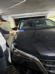 Man washes black SUV at Yerevan car wash facility