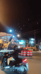 Boat transported on trailer through Thai village streets