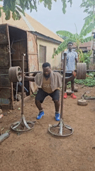 Man conducts morning barbell workout at outdoor gym in Akwanga