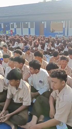Students in uniform gather outdoors at Tanjungsari school