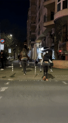 Friends share piggyback rides on Sofia street at night