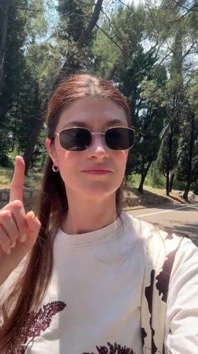 Woman enjoys morning walk through blooming Podgorica parkland