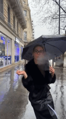 Parisians navigate rainy afternoon streets near Saint-Augustin district