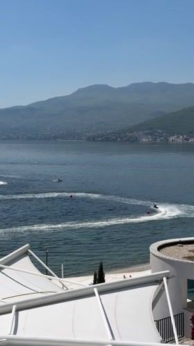 Jet skiers cruise Rijeka bay during sunny morning