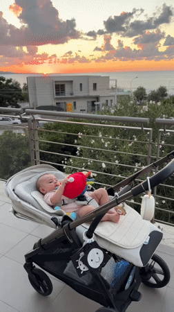 Sunset over the ocean, baby on a Capaci balcony